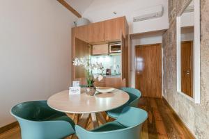a dining room with a wooden table and blue chairs at GuestReady - Miragaia Stone Studio 2T in Porto