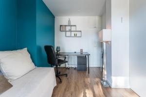 a bedroom with a bed and a desk with a chair at GuestReady - Shades of Blue with Balcony in Porto
