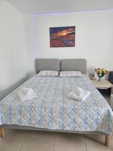 a bedroom with a bed with two towels on it at Monda Apartment in Piraeus