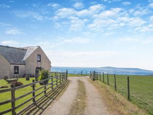 a farm house and a fence on a dirt road at Barnstable - Uk46888 in Kilmory