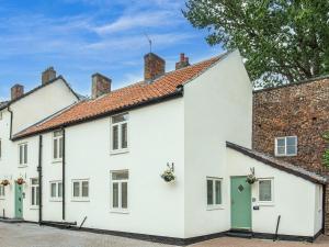 a row of white houses with red roofs at Violet Cottage - Uk45968 in Yarm