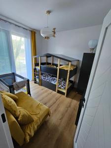 a bedroom with two bunk beds and a window at VistaHub Baltic in Niechorze