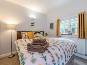 a bedroom with a bed with a blanket on it at Westmoor Annexe in Hereford
