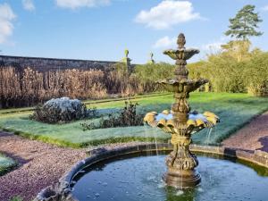 a fountain in the middle of a garden at The Bothy - Uk47217 in Great Bolas