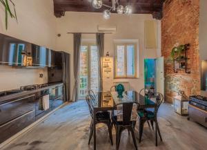 a kitchen and dining room with a table and chairs at Luxury Apartament Florence in Florence