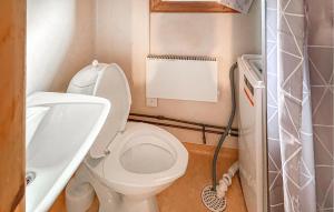 a small bathroom with a toilet and a sink at 1 Bedroom Awesome Home In Mora in Mora +2 photos
