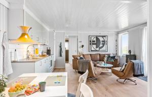 a kitchen and living room with a table and chairs at Awesome Home In Pandrup With House A Panoramic View in Rødhus