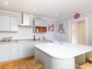 a kitchen with white cabinets and a white counter top at Holbrook House in Cambridge