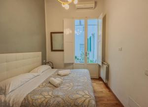 a bedroom with a large bed with a large window at Luxury Apartament Florence in Florence