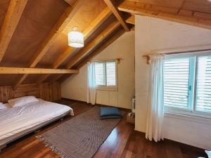 a bedroom with a bed and a large window at Blue House In The Woods- Amirim in Amirim