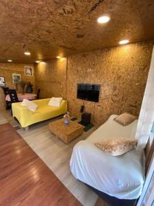 a room with two beds and a couch and a tv at Résidence GreenArt Mamert et services in Porto-Novo