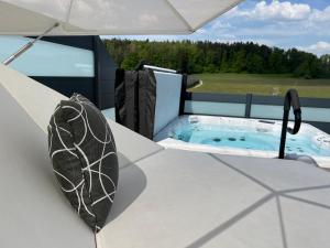 a hot tub on the deck of a house at Poolhaus Bodensee ideal für Geschäftsreisende in Wasserburg am Bodensee