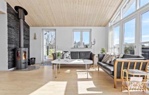 a living room with a couch and a table at Amazing Home In Frederikshavn in Frederikshavn