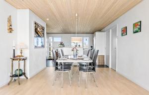 a dining room with a table and chairs at Amazing Home In Frederikshavn in Frederikshavn