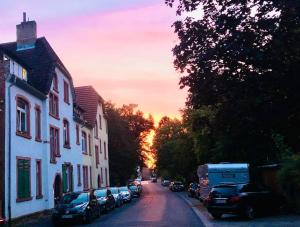 a street with cars parked on the side of a house at Gemütliches Studio - Dachwohnung mit Blick über das Kinzigtal in Gelnhausen