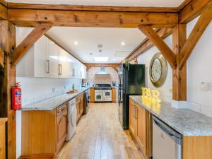 a kitchen with wooden ceilings and a large counter top at The Lodge in Gloucester