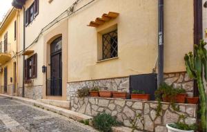 ein Gebäude mit Topfpflanzen an der Straßenseite in der Unterkunft Stunning Home In Trappeto With Wifi in Trappeto