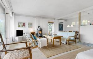 a living room with a couch and a table at 3 Bedroom Stunning Home In Vejby in Vejby