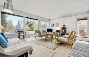 a living room with a couch and a table at 3 Bedroom Stunning Home In Vejby in Vejby