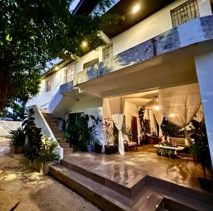 a house with a staircase leading up to it at Stylish Apartments near Best Western Hotel in Belize City