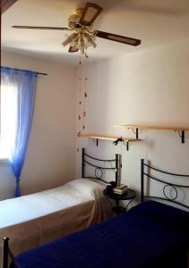 En eller flere senge i et værelse på Rilassarsi a Orosei