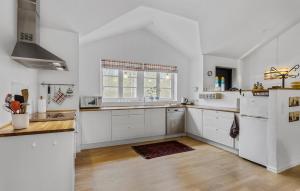 Una cocina con gabinetes blancos y una ventana grande. en Amazing Home In Sæby With Wifi, en Saeby