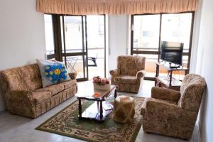 a living room with couches and chairs and a television at Charming Fátima House in Fátima