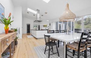 a kitchen and dining room with a white table and chairs at 4 Bedroom Amazing Home In Vig in Vig