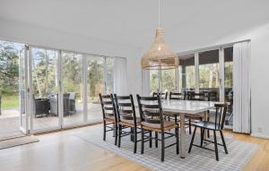a dining room with a table and chairs at 4 Bedroom Amazing Home In Vig in Vig