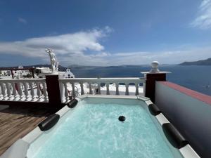 a swimming pool on the balcony of a house at Maryloujohn Villas Oia in Oia