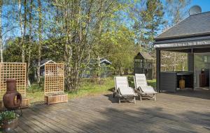 a deck with two lounge chairs and a grill at 4 Bedroom Amazing Home In Vig in Vig +10 photos