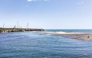 a body of water with a person walking on the beach at Amazing Apartment In Chiavari With Wifi in Chiavari