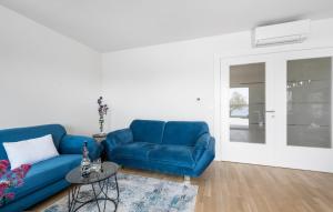 a living room with a blue couch and a table at 3 Bedroom Stunning Apartment In Vodice in Vodice