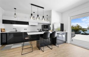 a kitchen with a large island with bar stools at 3 Bedroom Stunning Apartment In Vodice in Vodice