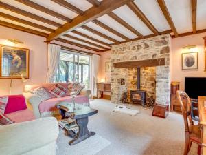 a living room with a couch and a fireplace at Uk47176 - Vine Barn in Bellerby