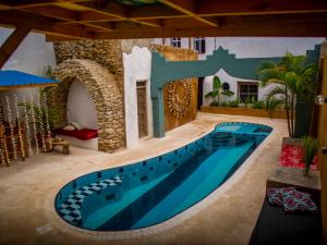a swimming pool in the middle of a house at Firefly West Wing in Bagamoyo