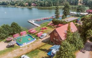 an aerial view of a pool with umbrellas and a resort at Beautiful Apartment In Tumiany in Tumiany +5 photos