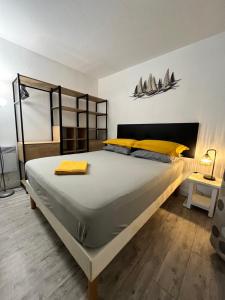 a bedroom with a large bed with yellow pillows at Pampelonne Appartment in La Croix-Valmer