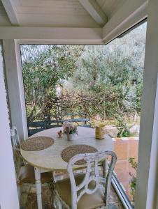 a table and chairs on a porch with a view at Grotta dei Puntali B&B in Carini