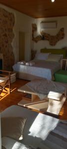 a bedroom with two beds and a table at MELPO in Évyiros