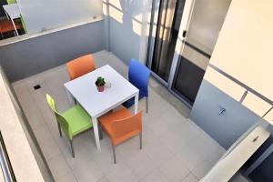 a white table and chairs with a plant on it at GREEK PRIDE PANTHEA STUDIOS in Skala Fourkas