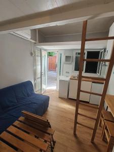 a living room with a blue couch and a bunk bed at La Casina Small Loft in Versilia in Marina di Carrara