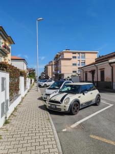 two cars parked in a parking lot on a street at La Casina Small Loft in Versilia in Marina di Carrara