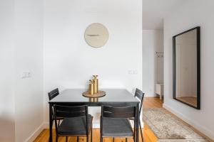 a dining room with a table and chairs and a mirror at GuestReady - Freixo Paradise view in Porto