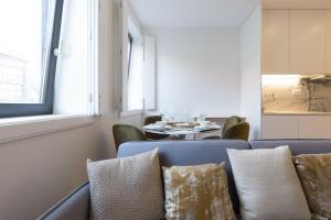 a living room with a blue couch and a table at GuestReady - Cosy and Modern Apartment 4mins from Metro in Porto