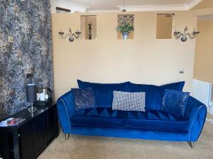 a blue couch sitting in a living room at The New Talbot Hotel in Southport
