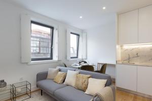 a living room with a couch and a table at GuestReady - Cosy and Modern Apartment 4mins from Metro in Porto