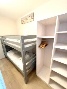 a room with a closet with white shelves at Fleur de Ré in Loix