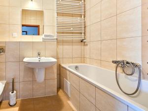 a bathroom with a sink and a bath tub next to a sink at Visit Baltic - Platan II in Świnoujście