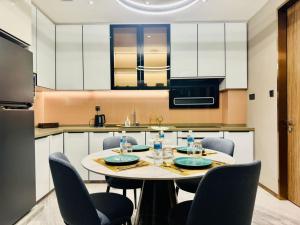 a kitchen with a table and chairs in a kitchen at Imperial Luxury Residence KLCC By AR Hospitality in Kuala Lumpur